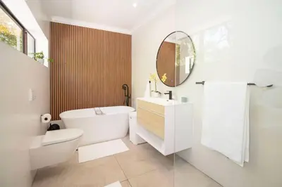 a bathroom with a tub and a toilet and a sink at The Oasis of Stellenbosch in Stellenbosch