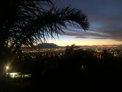 a view of a city lit up at night at Self Catering Guest House in Cape Town