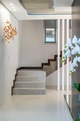 a staircase in a house with a stair case at Family home in Tableview, close to Dolphin Beach. in Cape Town