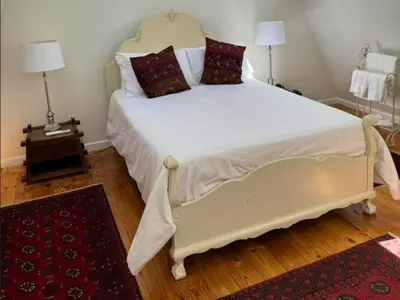 a bedroom with a large white bed with pillows at Bordeaux 45 in Cape Town