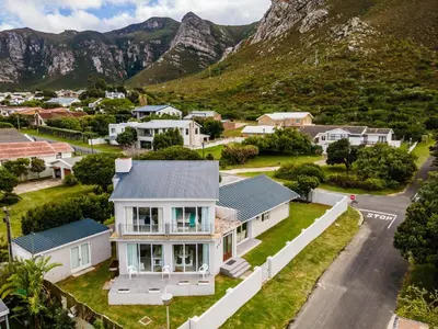 an aerial view of a house with mountains in the background at Nest Egg Holiday Home Voëlklip in Hermanus