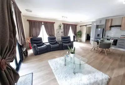a living room with a table and chairs at Sunset Getaways in Cape Town