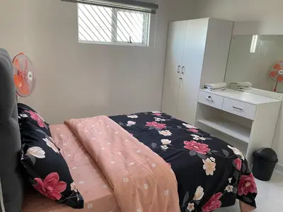 a bedroom with a bed with a blanket on it at The MK House in Cape Town
