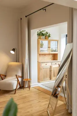 a living room with a easel and a chair at Boho Chic Studio Stellenbosch in Stellenbosch