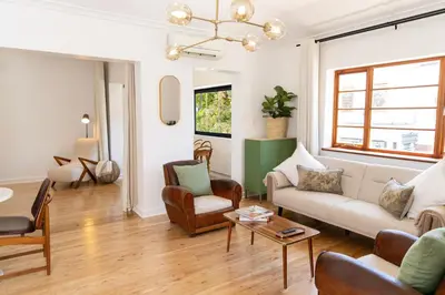 a living room with a couch and chairs and a table at Boho Chic Studio Stellenbosch in Stellenbosch