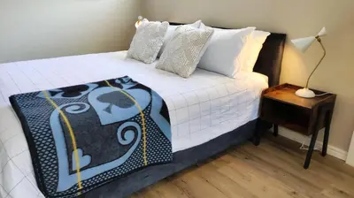 a bedroom with a bed and a nightstand with a bed sidx sidx at Blissful Country Garden King Bed Cottage in Grabouw