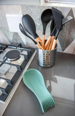 a container of utensils on a counter next to a stove at The Fuchsia Collection in Somerset West