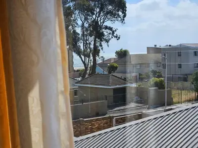 a view of a city from a window at Strand Beach Apartment in Cape Town