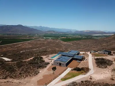an aerial view of a building with solar panels on it at Khanyisa Mountain Lodge in Robertson