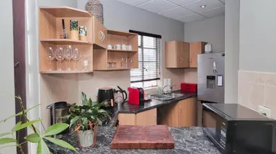 a kitchen with a counter and a refrigerator at Corner View in Paarl