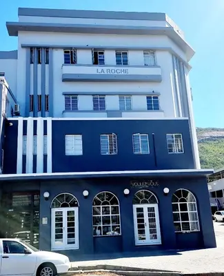 a blue and white building with a car parked in front at Corner View in Paarl