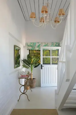 a hallway with a white door and a plant at Best of Both! Mountain and Sea View Home. in Hermanus