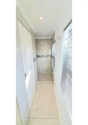 a bathroom with a walk in shower and a toilet at Heart of Obz in Cape Town