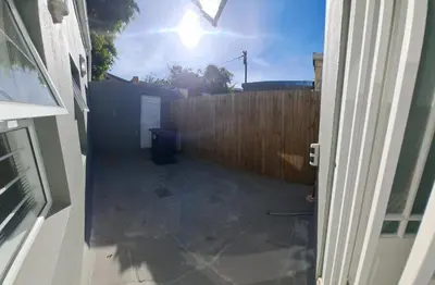 an outside view of a backyard with a fence at Heart of Obz in Cape Town