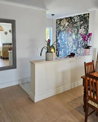 a room with a counter with potted plants and a mirror at Casa La Vista in Somerset West