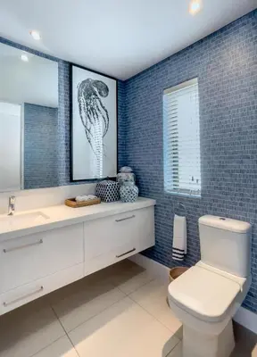 a bathroom with a toilet and a sink and a mirror at Le Paradis Penthouse in Hermanus