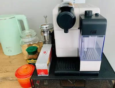 a coffee maker sitting on top of a table at Marble Maison in Franschhoek
