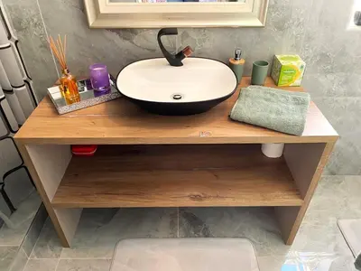 a bathroom counter with a sink on a wooden table at Marble Maison in Franschhoek