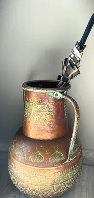 a copper vase sitting on top of a table at Marble Maison in Franschhoek