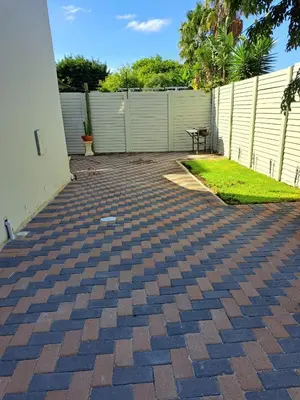 a brick driveway with a table in a backyard at Casa Table View in Cape Town