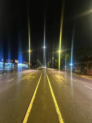 an empty street at night with street lights at Stay with me in Cape Town