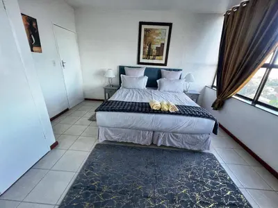 a bedroom with a bed with two shoes on it at Stay with me in Cape Town