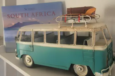 a small blue and white van with luggage on top at Lazy Days Apartments - Cape Town in Cape Town