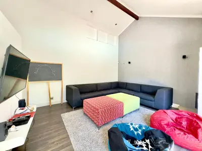 a living room with a couch and a table at The Kite Villa - Luxury Kitesurfing Guesthouse in Cape Town