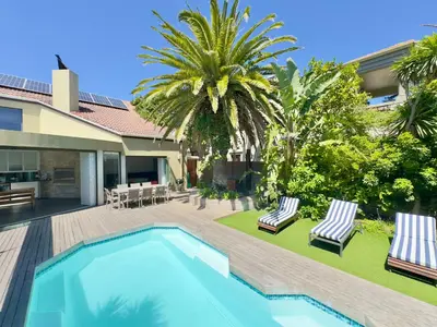 an image of a backyard with a swimming pool and palm trees at The Kite Villa - Luxury Kitesurfing Guesthouse in Cape Town