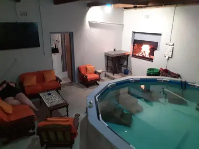 a living room with a swimming pool and a fireplace at MJ's Self Catering in Wolseley