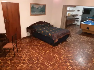 a bedroom with a bed and a pool table at MJ's Self Catering in Wolseley