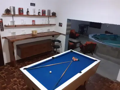 a pool table in a room with a swimming pool at MJ's Self Catering in Wolseley