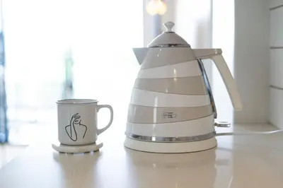 a coffee maker and a cup on a counter at Blouberg Coastal Hideout, Luxury Apartment with a Braai and Parking in Cape Town
