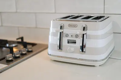 a toaster sitting on top of a kitchen counter at Blouberg Coastal Hideout, Luxury Apartment with a Braai and Parking in Cape Town