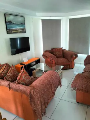 a living room with two couches and a tv at Hermanus Beach Club 143 in Hermanus