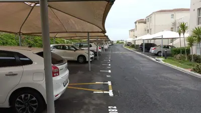 a row of parked cars in a parking lot at Hermanus Beach Club 143 in Hermanus