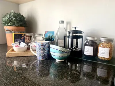 a counter with bowls and jars on a table at Stay on Main - Studio Blue in Paarl