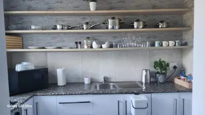 a kitchen with a sink and a counter top at The One on Pienaar in Cape Town