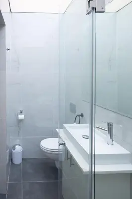 a white bathroom with a sink and a toilet at The One on Pienaar in Cape Town