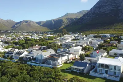 an aerial view of a city with houses and mountains at True coastal living - 2gether on Voëlklip in Hermanus