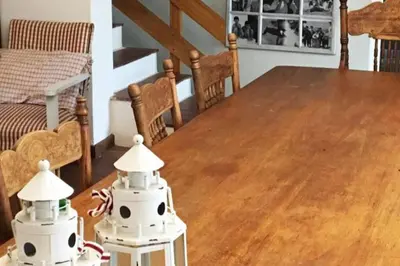 a room with a wooden table with two robots on top at True coastal living - 2gether on Voëlklip in Hermanus