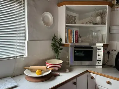 a kitchen with a counter top with a microwave at True coastal living - 2gether on Voëlklip in Hermanus