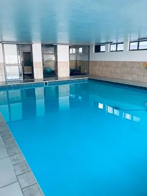 a large swimming pool with blue water in a building at Hibernian 10.02 in Cape Town