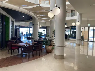 a dining room with tables and chairs in a building at Hibernian 10.02 in Cape Town