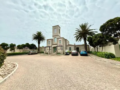 a large house with cars parked in a driveway at Cozy&warm apartment in Century city in Cape Town