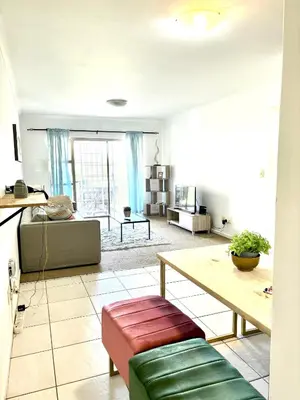 a living room with a couch and a table at Cozy&warm apartment in Century city in Cape Town