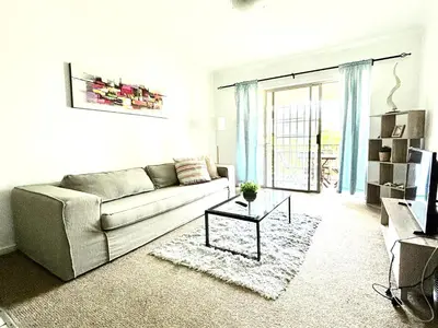 a living room with a couch and a table at Cozy&warm apartment in Century city in Cape Town
