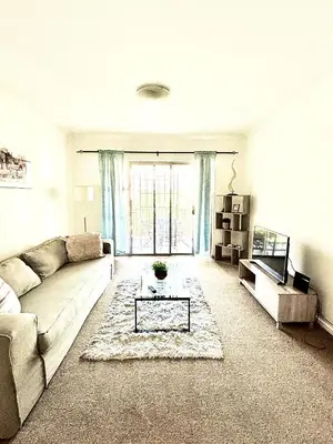 a living room with a couch and a table at Cozy&warm apartment in Century city in Cape Town