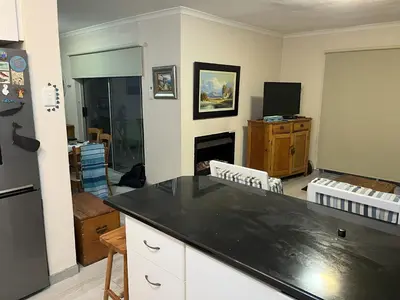 a kitchen with a black counter top in a room at Oceans Edge - Hermanus Beach Club in Hermanus