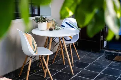 a white table and two chairs on a patio at Apartment in central Stellenbosch in Stellenbosch